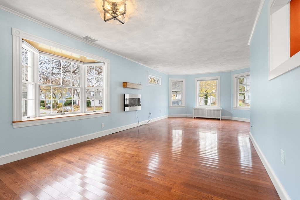 5 Harrison Street Maynard, MA 01754 - Photo 9 of 29 a view of empty room with wooden floor and fan
