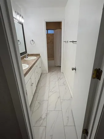 a bathroom with a sink a toilet a mirror and vanity