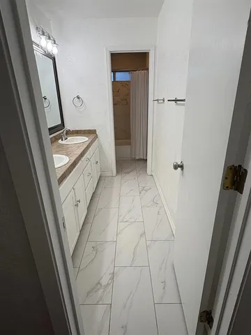 a bathroom with a sink a toilet a mirror and vanity