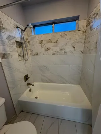 a bathroom with a bathtub and a shower