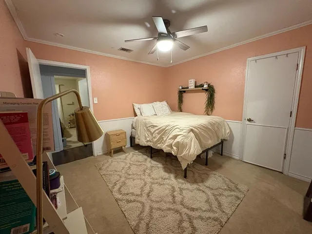 a bedroom with a bed and a large mirror