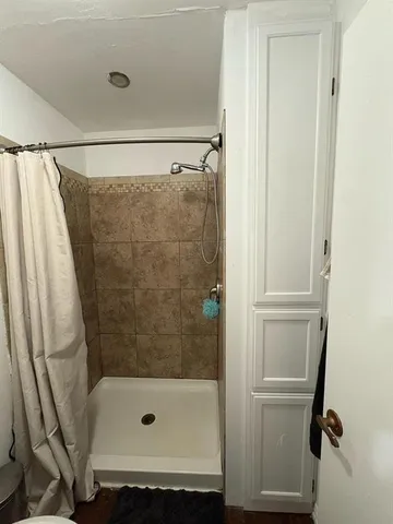 a bathroom with a tub and a shower