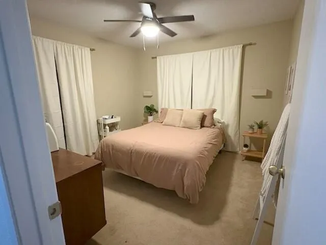 a bedroom with a bed and a large window