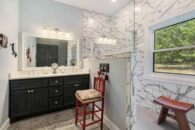 a bathroom with a sink vanity and a mirror