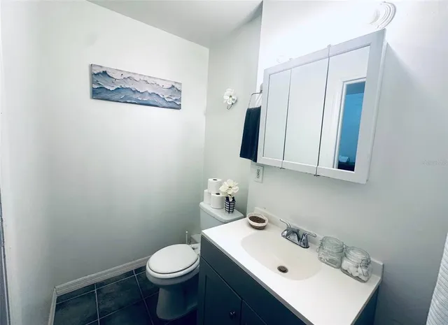 a bathroom with a sink mirror and toilet