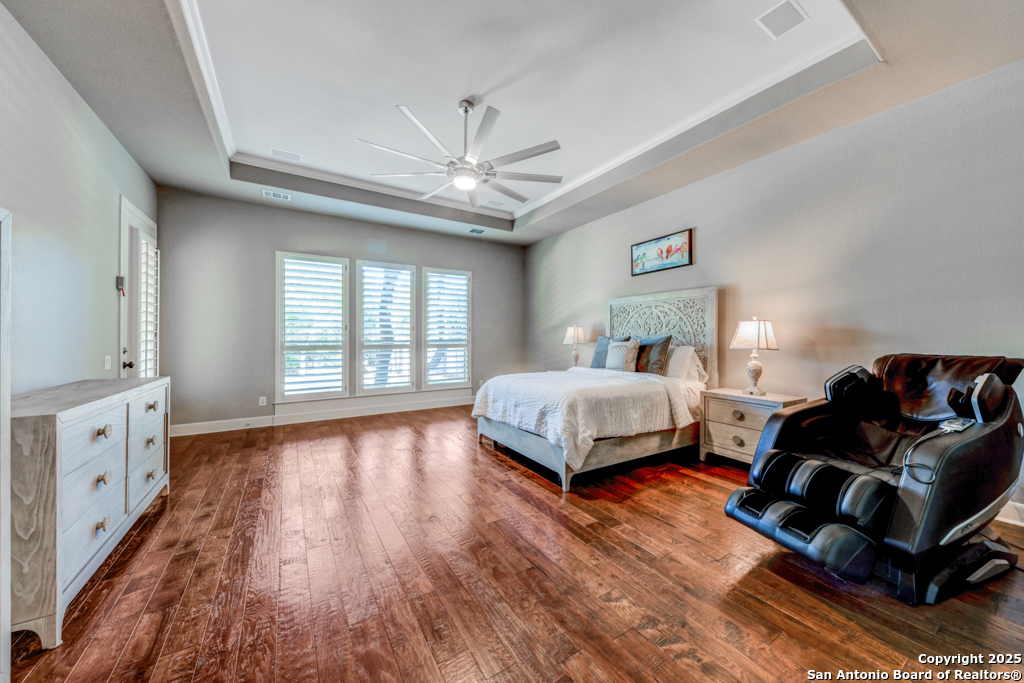 142 Candelaria Helotes, TX 78023 - Photo 20 of 53 a bedroom with a bed and wooden floor