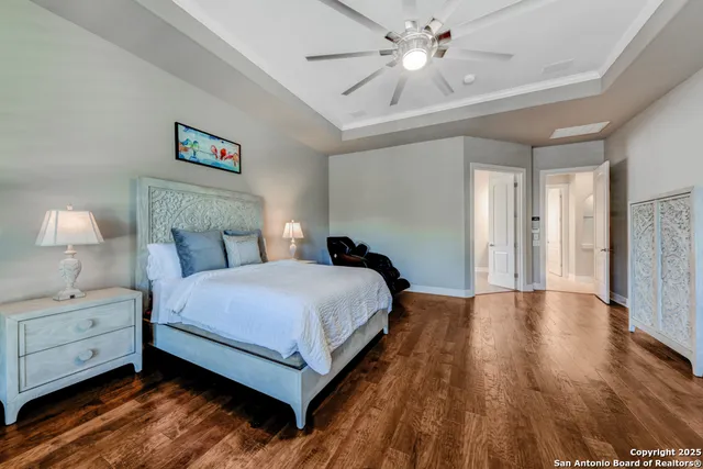 a spacious bathroom with a tub sink and mirror