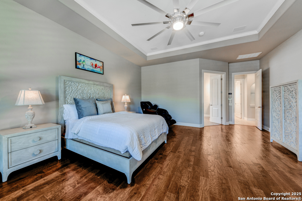 142 Candelaria Helotes, TX 78023 - Photo 21 of 53 a bedroom with a bed and a chandelier