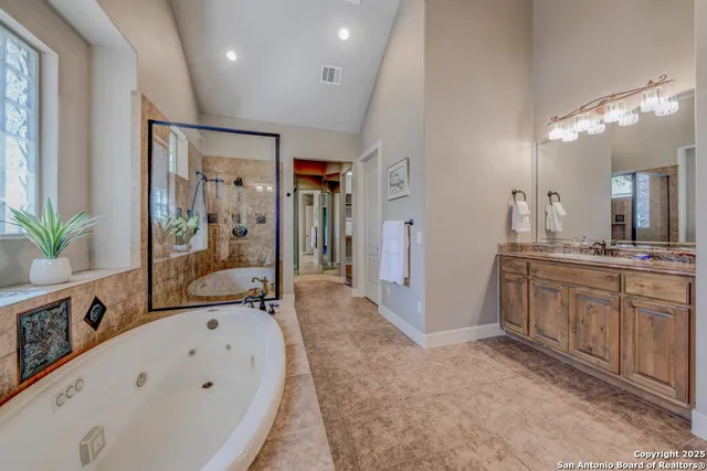 a view of a hallway with a glass door and shower