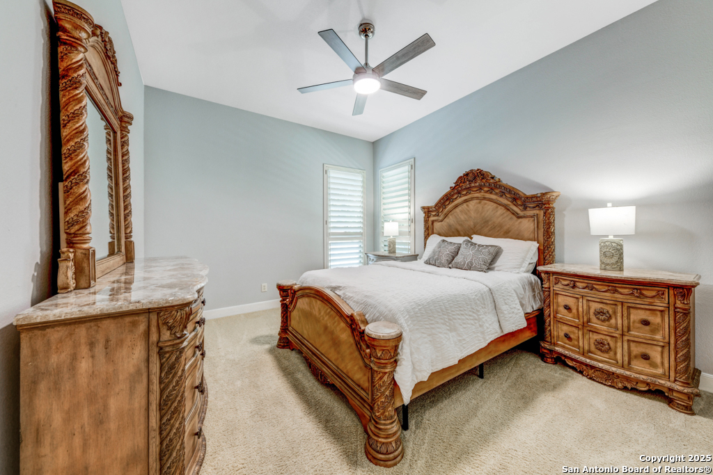 142 Candelaria Helotes, TX 78023 - Photo 29 of 53 a bedroom with a bed and a chandelier