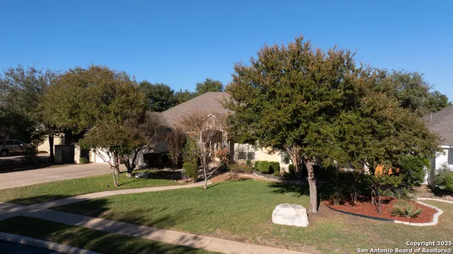 an aerial view of a house with a yard