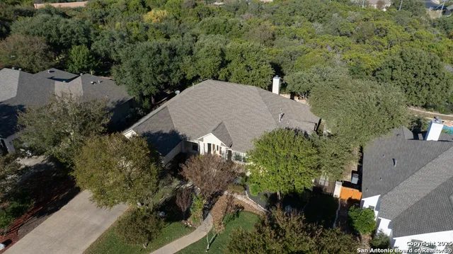 an aerial view of house with yard and outdoor seating