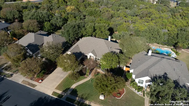 an aerial view of a house with a yard and garden