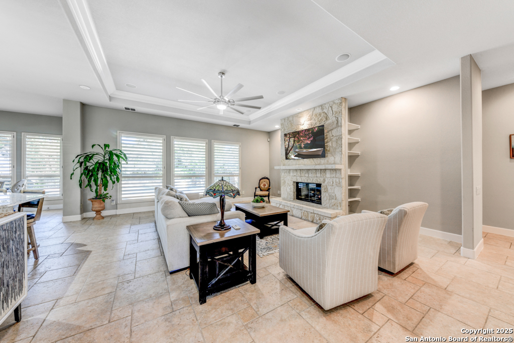 142 Candelaria Helotes, TX 78023 - Photo 7 of 53 a living room with furniture a fireplace and a chandelier