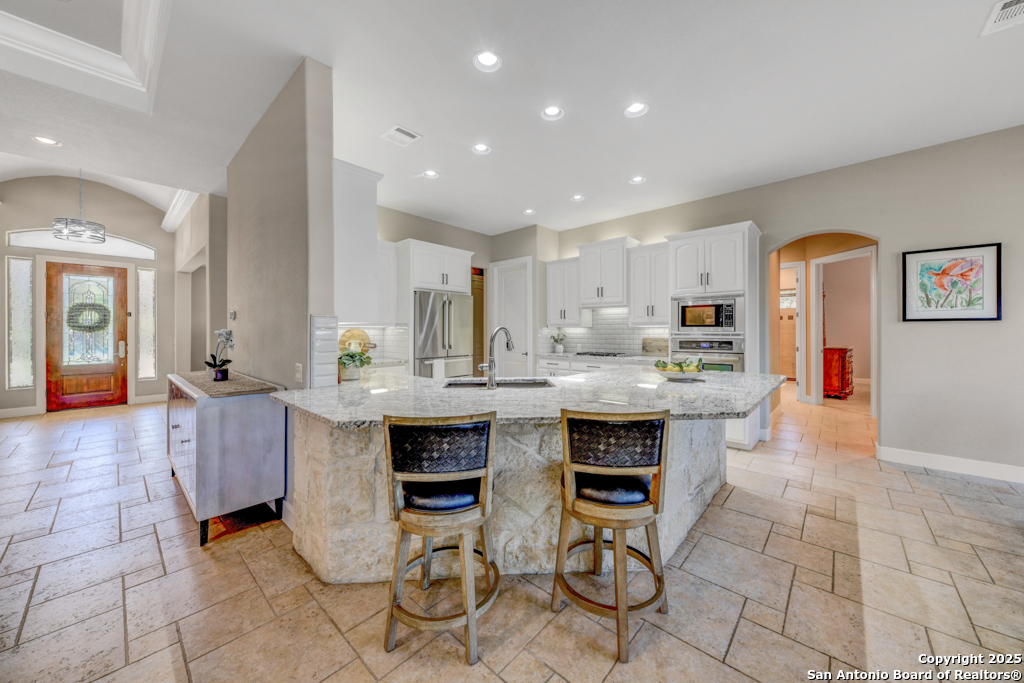 142 Candelaria Helotes, TX 78023 - Photo 10 of 53 a kitchen with granite countertop a sink and cabinets