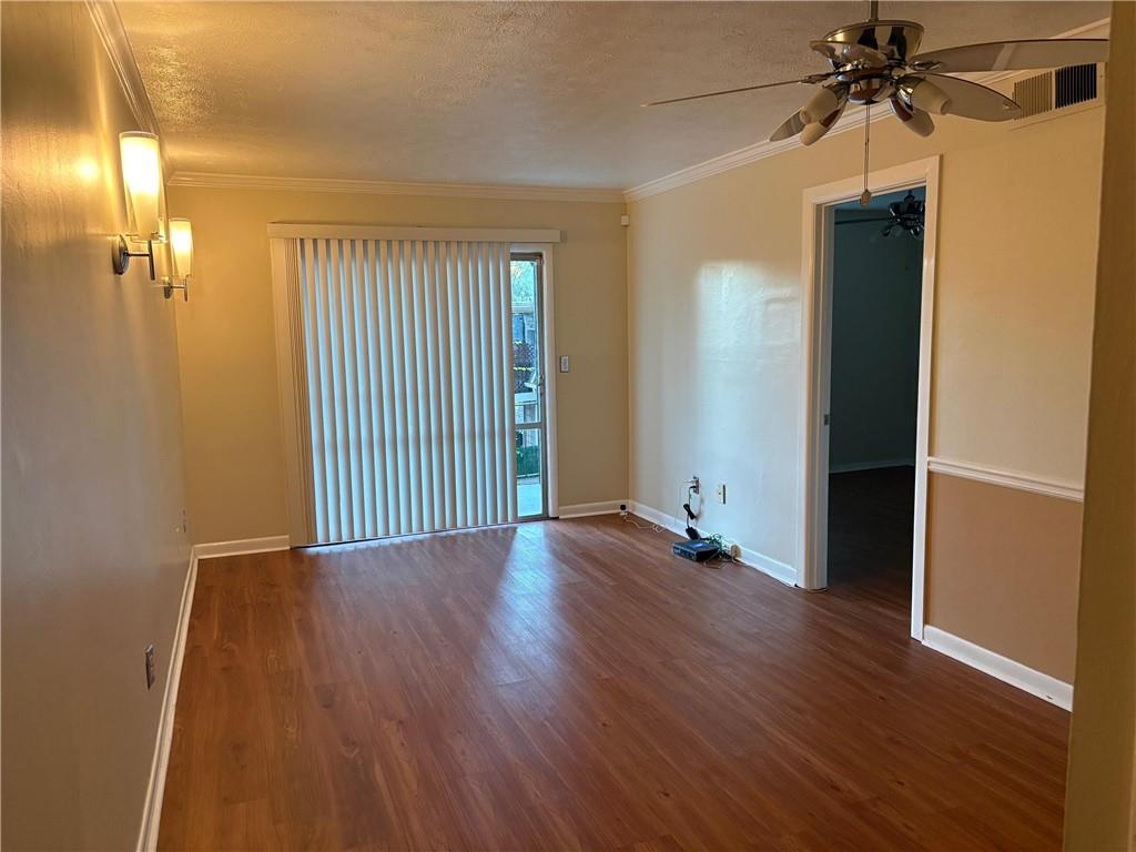 2805 Northeast Expressway, Unit A14 Atlanta, GA 30345 - Photo 4 of 13 an empty room with wooden floor and a ceiling fan