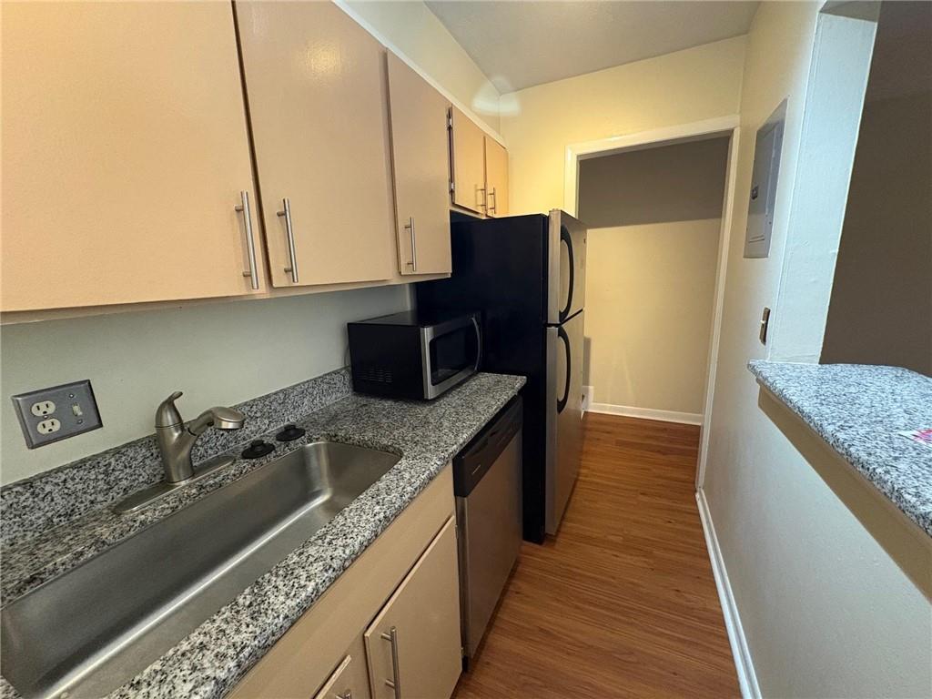 2805 Northeast Expressway, Unit A14 Atlanta, GA 30345 - Photo 9 of 13 a kitchen with a sink a refrigerator and cabinets