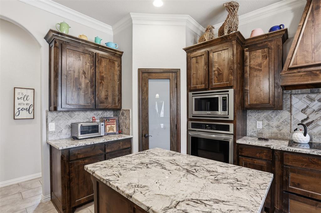 140 Flying Diamond Drive Springtown, TX 76082 - Photo 11 of 30 a kitchen with stainless steel appliances kitchen island granite countertop a refrigerator a stove top oven and a sink