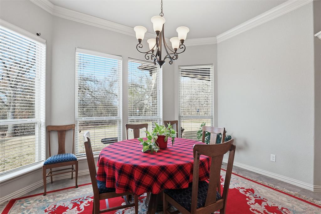 140 Flying Diamond Drive Springtown, TX 76082 - Photo 14 of 30 a view of a dining room with furniture window and wooden floor