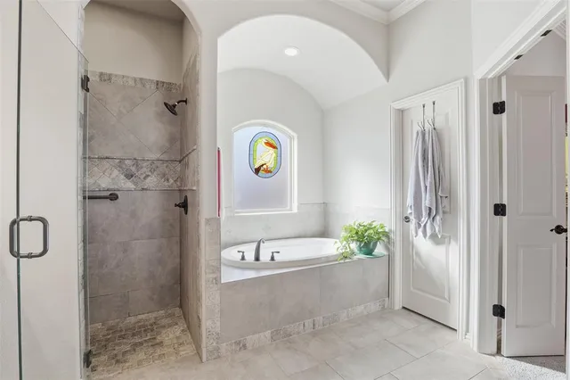 a bathroom with a tub and shower