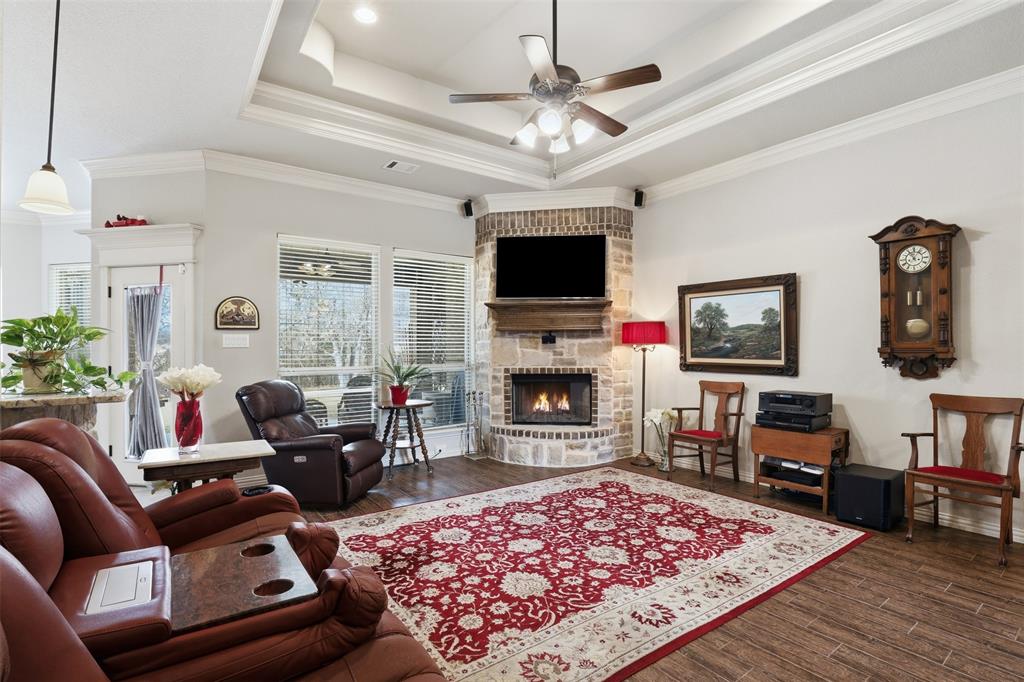 140 Flying Diamond Drive Springtown, TX 76082 - Photo 8 of 30 a living room with furniture a flat screen tv and a fireplace