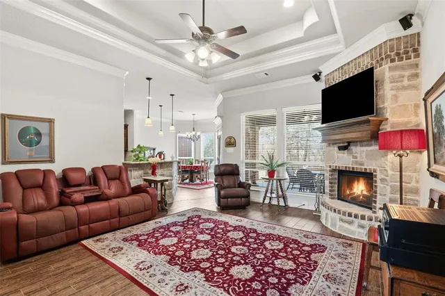 a living room with furniture a flat screen tv and a fireplace