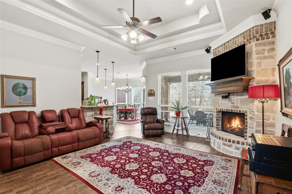 140 Flying Diamond Drive Springtown, TX 76082 - Photo 10 of 30 a living room with furniture a flat screen tv and a fireplace
