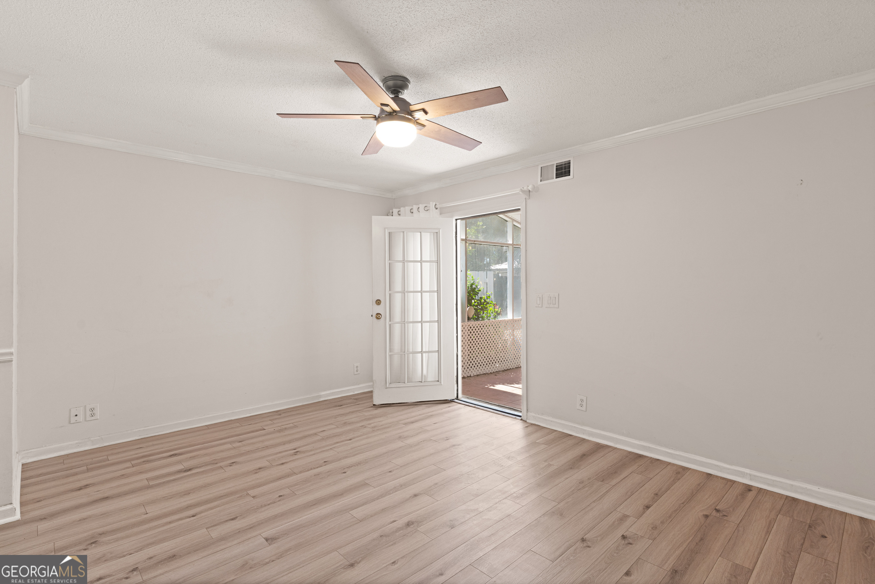 1000 Mallery St Extension, Unit B5 St. Simons, GA 31522 - Photo 11 of 24 a view of an empty room with wooden floor