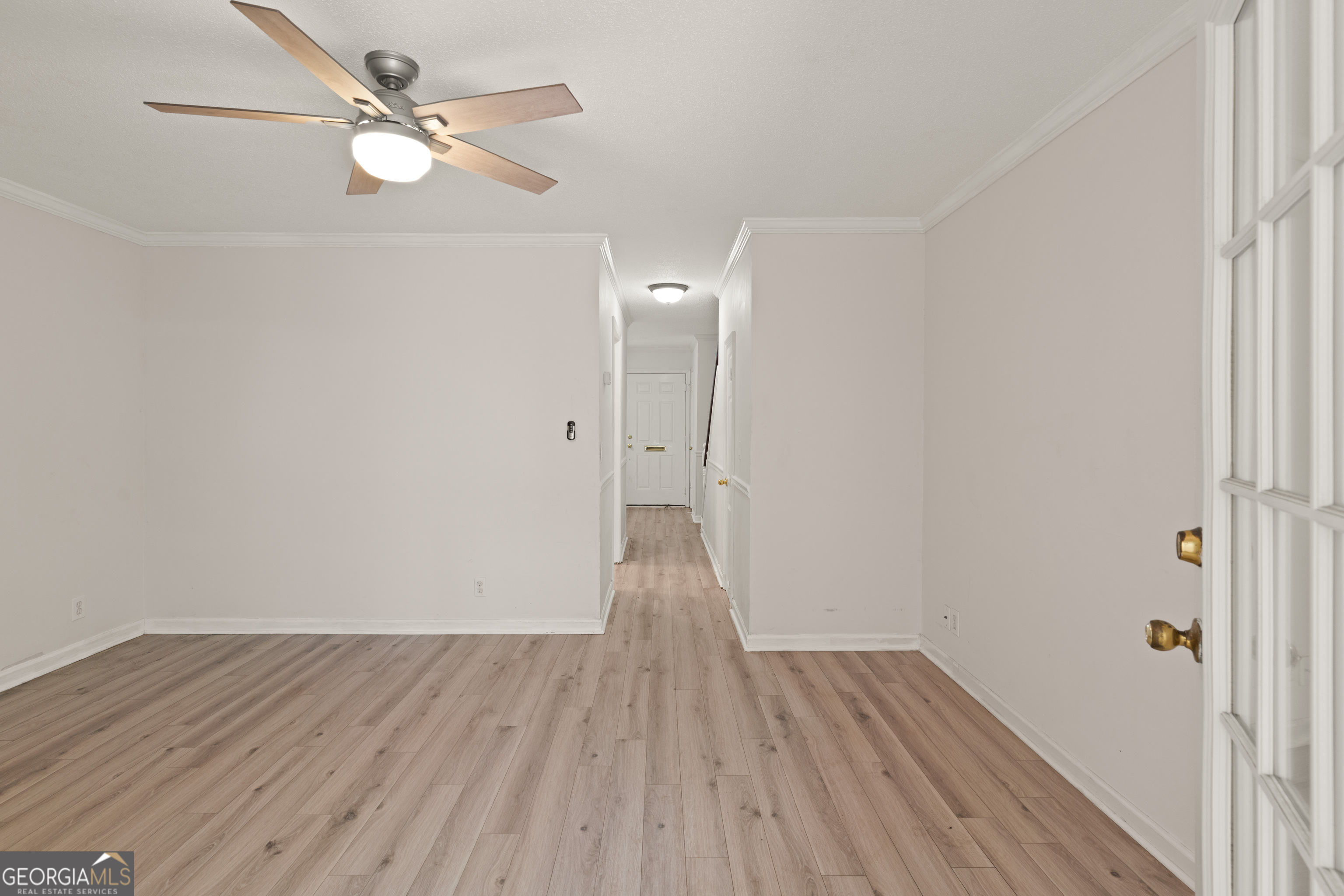 1000 Mallery St Extension, Unit B5 St. Simons, GA 31522 - Photo 14 of 24 wooden floor in an empty room with a window