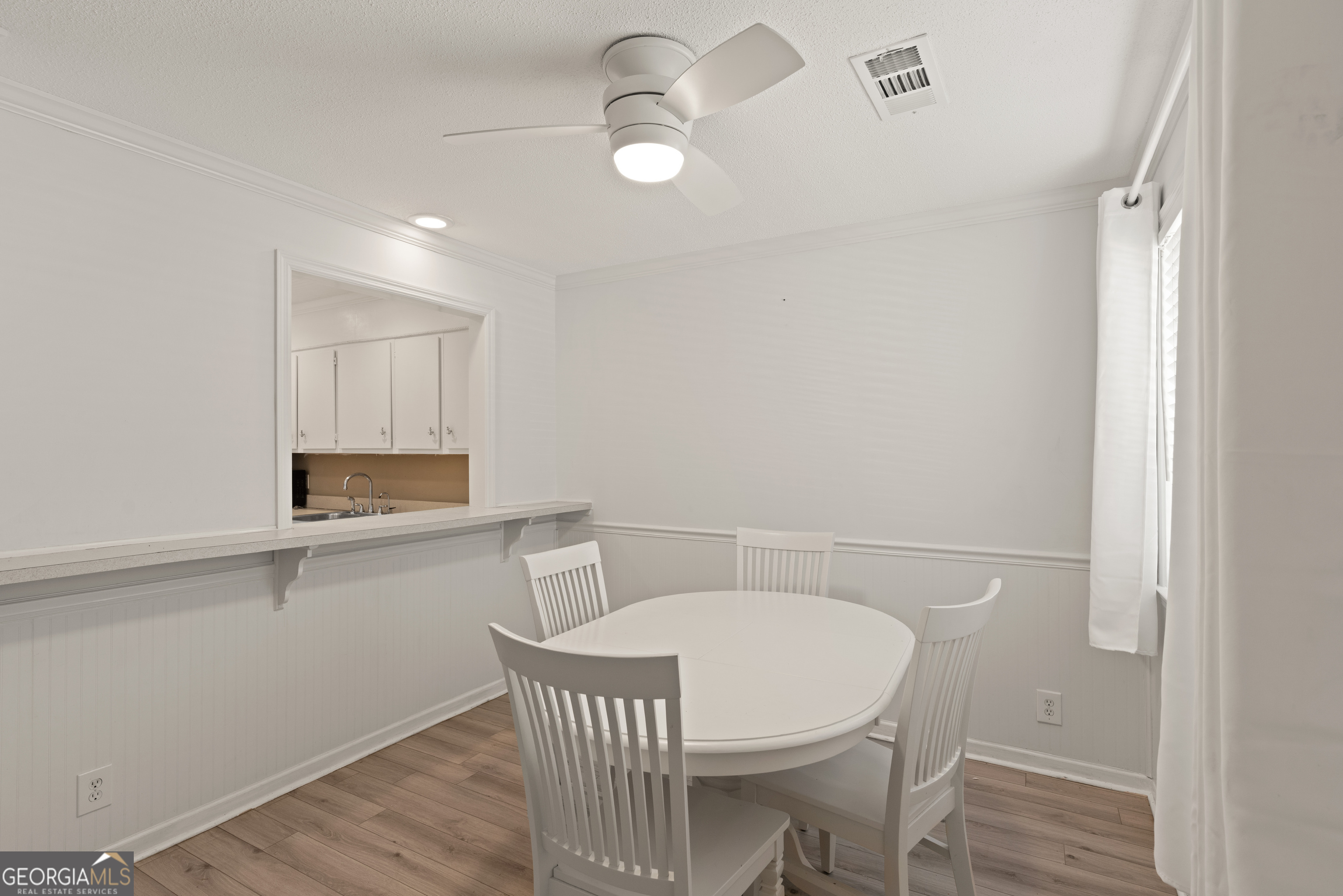 1000 Mallery St Extension, Unit B5 St. Simons, GA 31522 - Photo 6 of 24 a view of a dining room with furniture and wooden floor