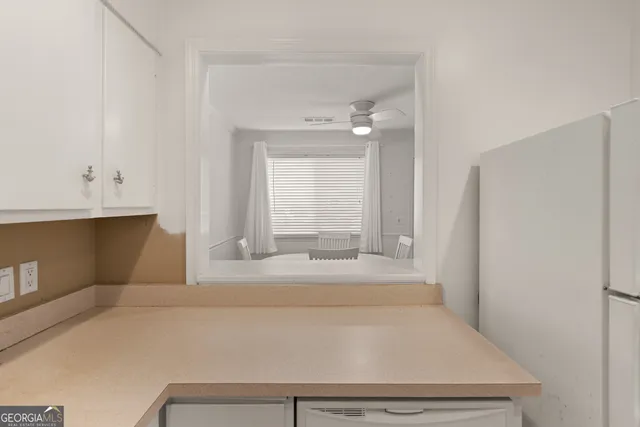 a kitchen with cabinets appliances a sink and a stove