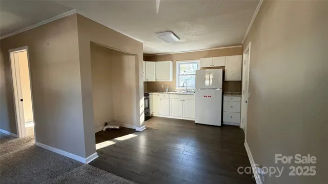 a view of a kitchen with wooden floor