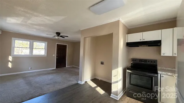 a kitchen with granite countertop a stove and a refrigerator