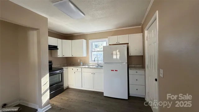 a kitchen with stainless steel appliances a refrigerator sink and cabinets