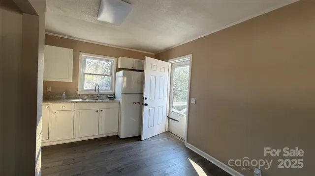 a room with two chandeliers and a window