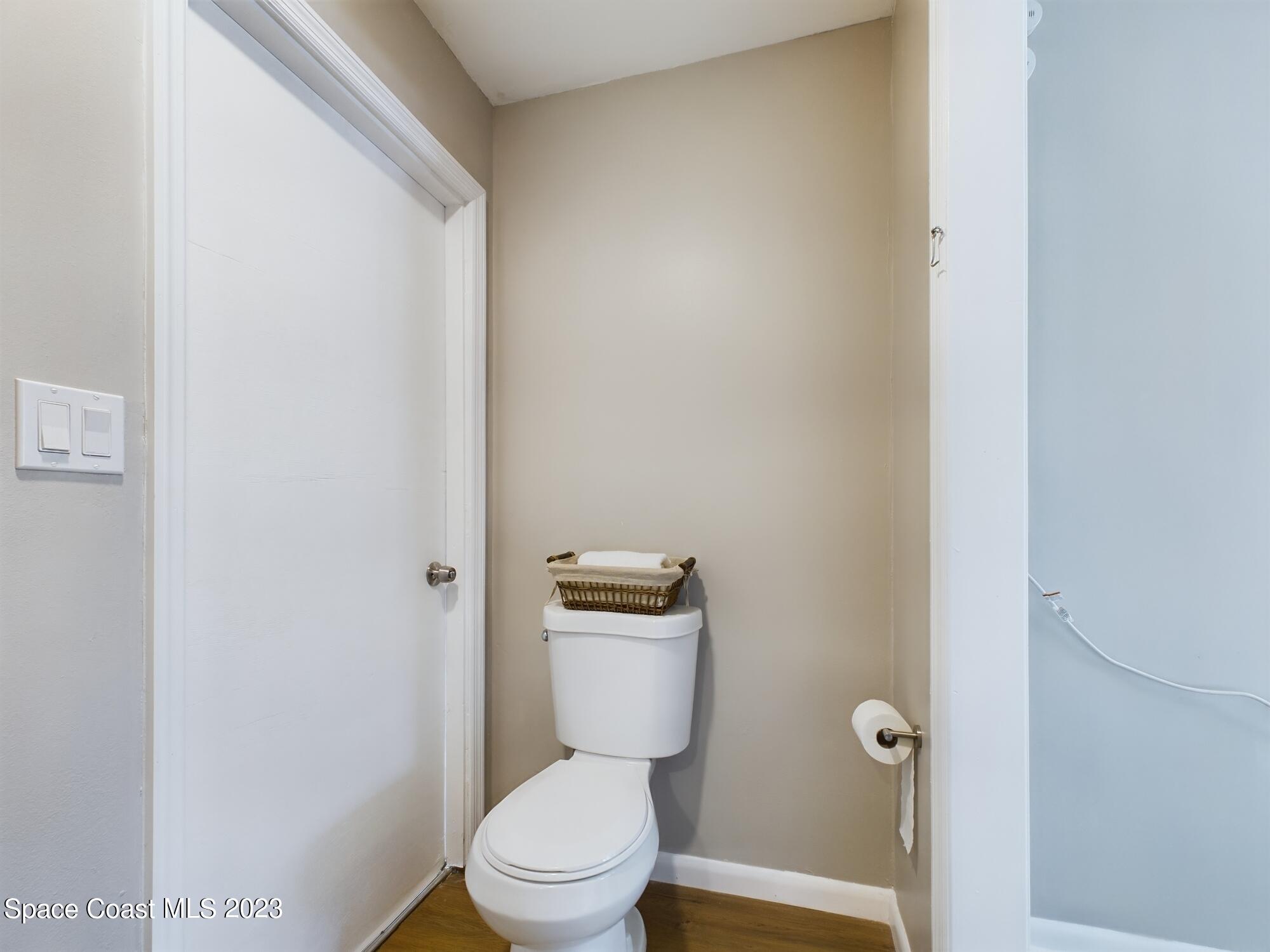 344 Columbus Street Sebastian, FL 32958 - Photo 13 of 35 a white toilet sitting next to a shower curtain