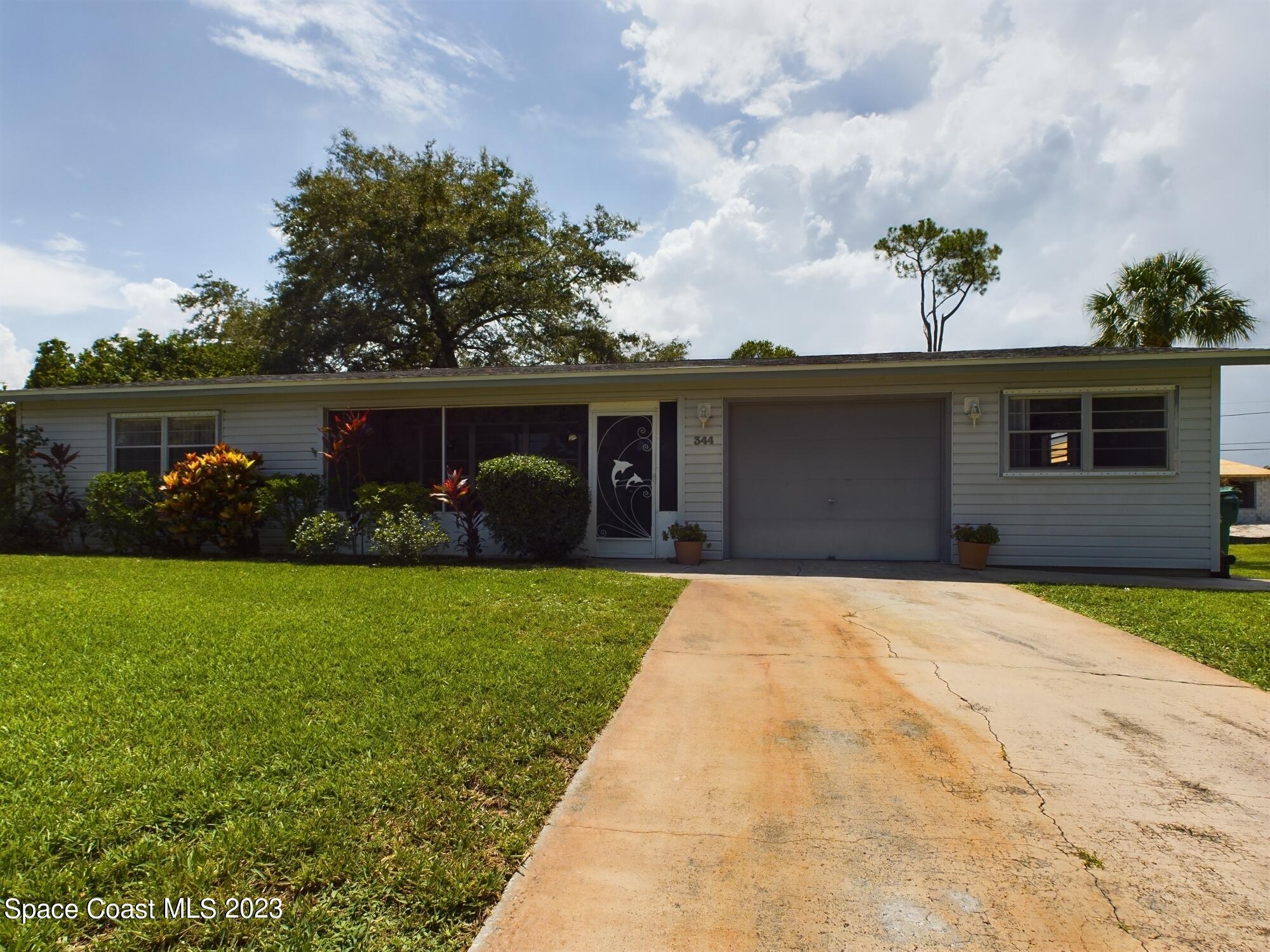 344 Columbus Street Sebastian, FL 32958 - Photo 2 of 35 a front view of house with garden
