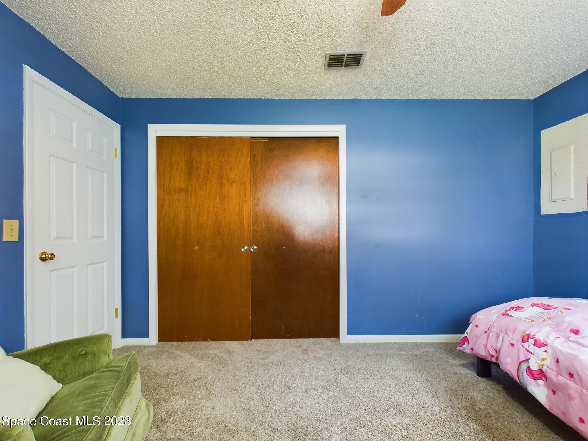 344 Columbus Street Sebastian, FL 32958 - Photo 30 of 35 a bedroom with a bed and a dresser