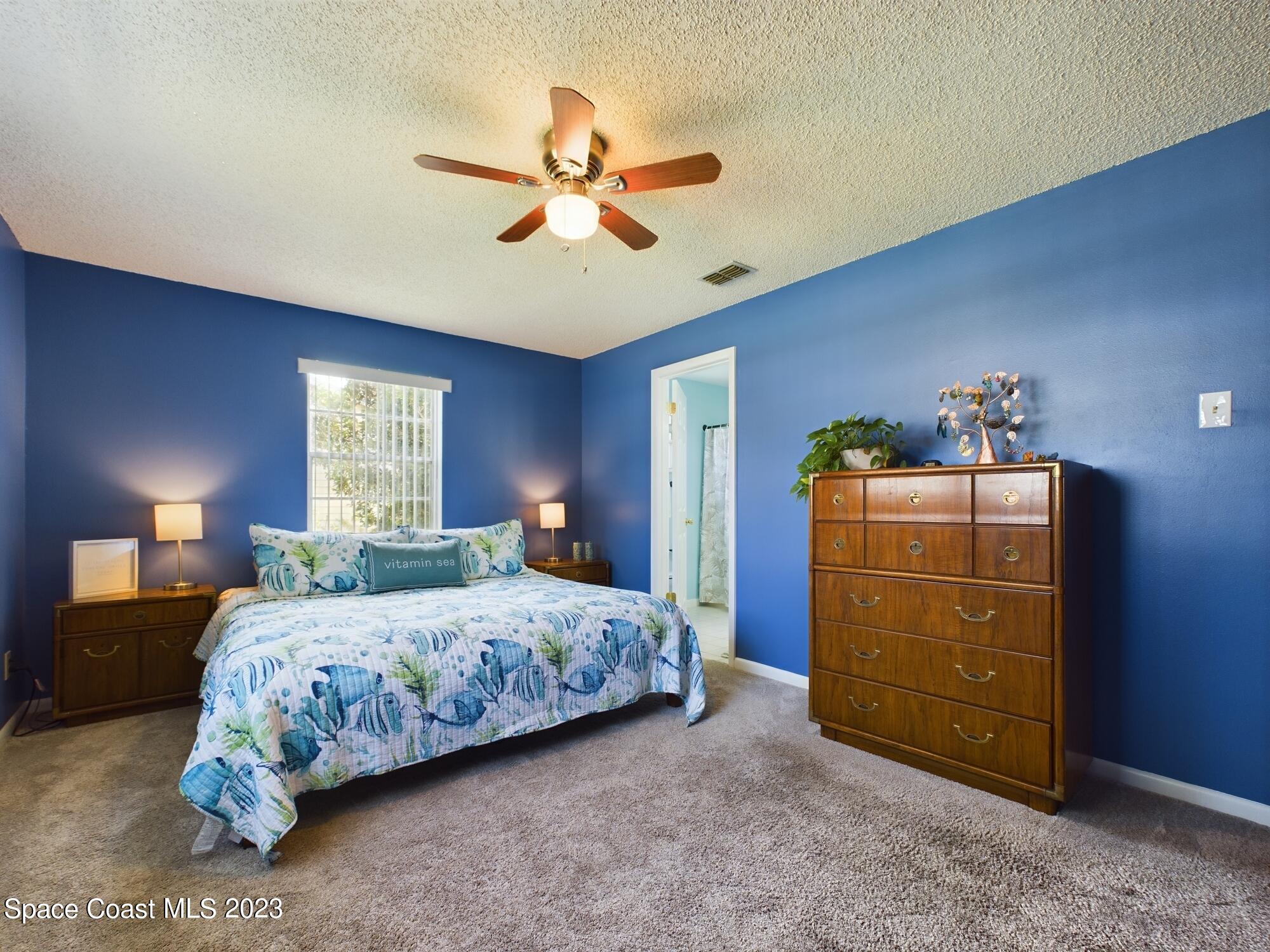 344 Columbus Street Sebastian, FL 32958 - Photo 32 of 35 a bedroom with a bed and a chandelier