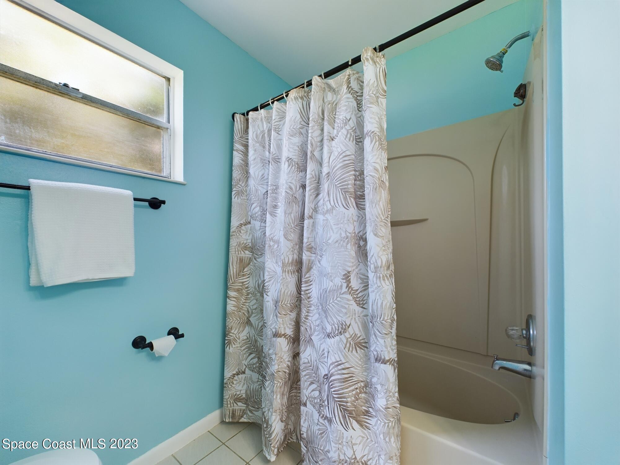 344 Columbus Street Sebastian, FL 32958 - Photo 33 of 35 a bathroom with a shower curtain and a window