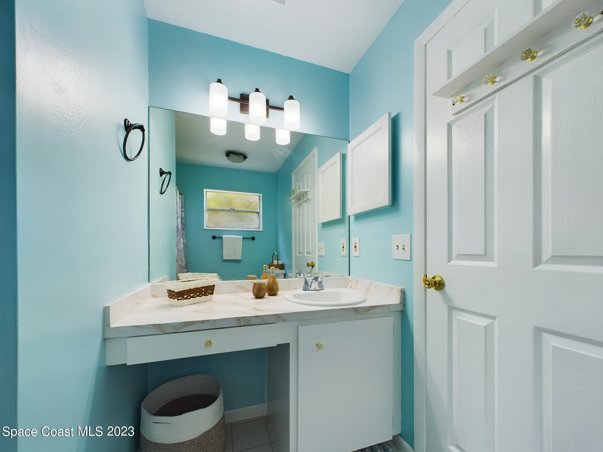 344 Columbus Street Sebastian, FL 32958 - Photo 34 of 35 a bathroom with a sink vanity and a mirror