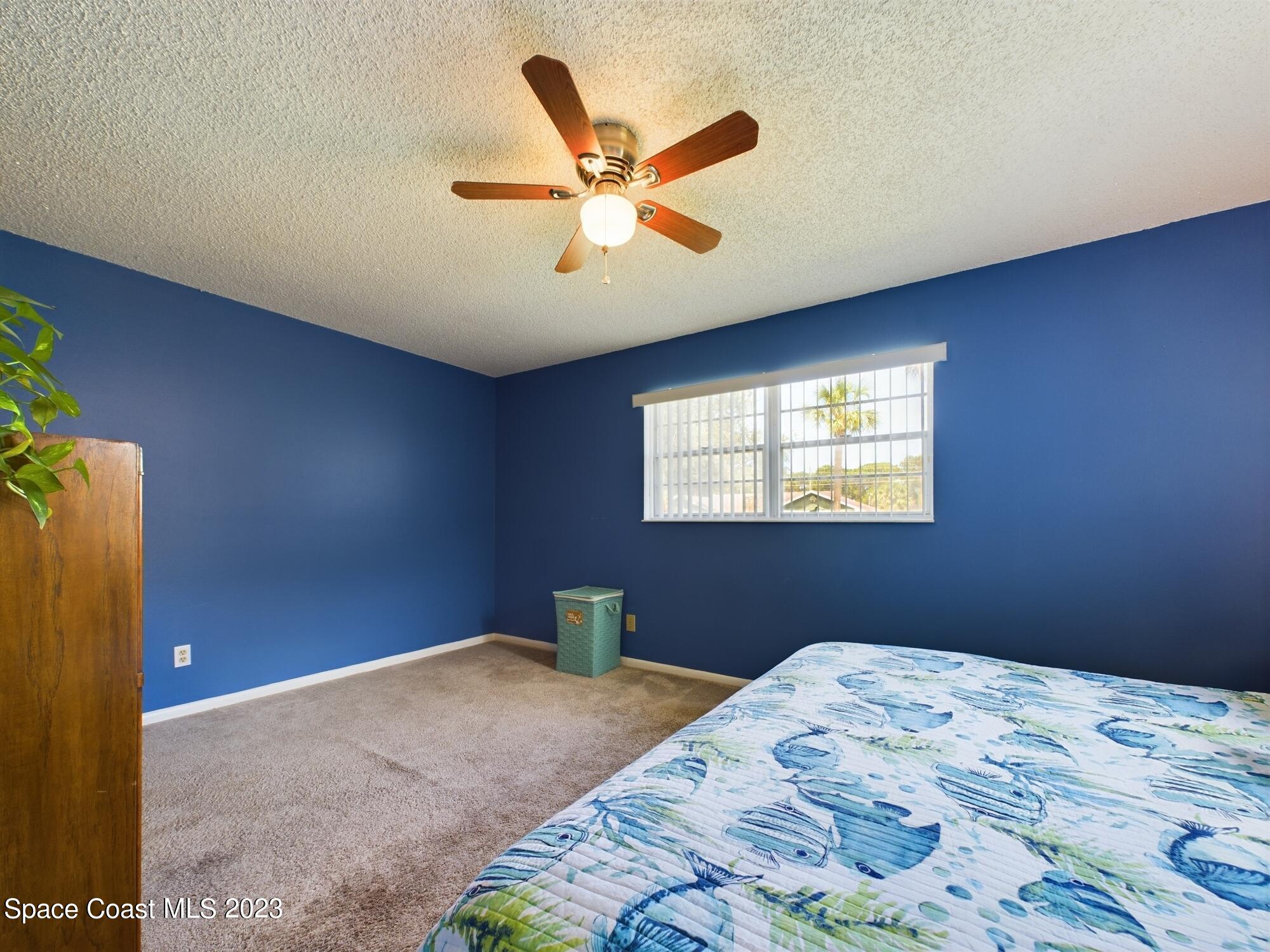 344 Columbus Street Sebastian, FL 32958 - Photo 35 of 35 a bedroom with a large bed and a window