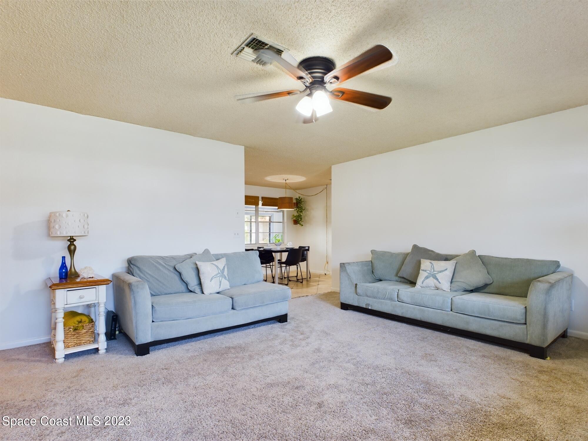 344 Columbus Street Sebastian, FL 32958 - Photo 6 of 35 a living room with furniture and a chandelier