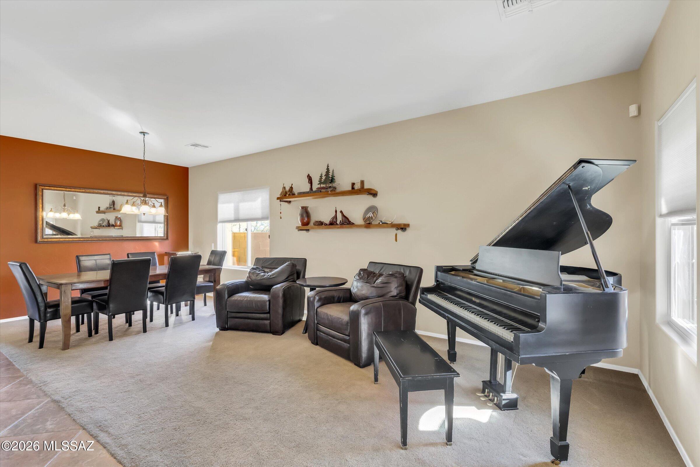 6095 South Jakemp Trail Tucson, AZ 85747 - Photo 10 of 52 a living room with furniture and a piano
