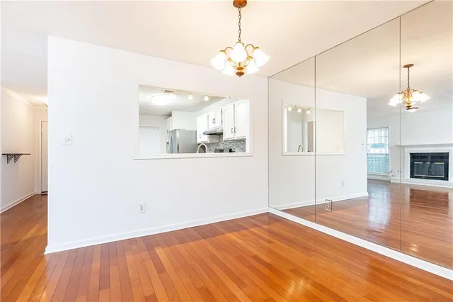 a view of a kitchen with wooden floor and a kitchen