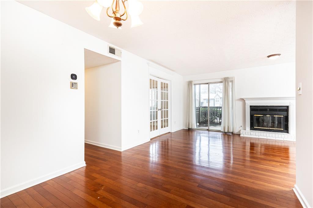 2901 Lenox Way Northeast, Unit 902 Atlanta, GA 30324 - Photo 12 of 34 a view of an empty room with wooden floor and a window