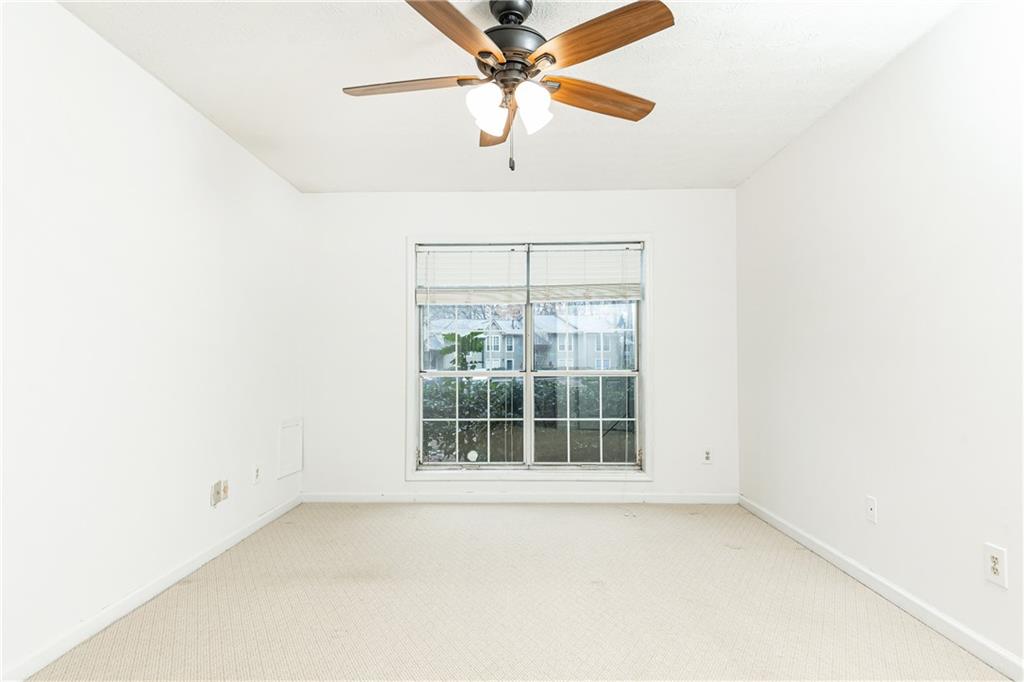 2901 Lenox Way Northeast, Unit 902 Atlanta, GA 30324 - Photo 24 of 34 an empty room with a window and a fan