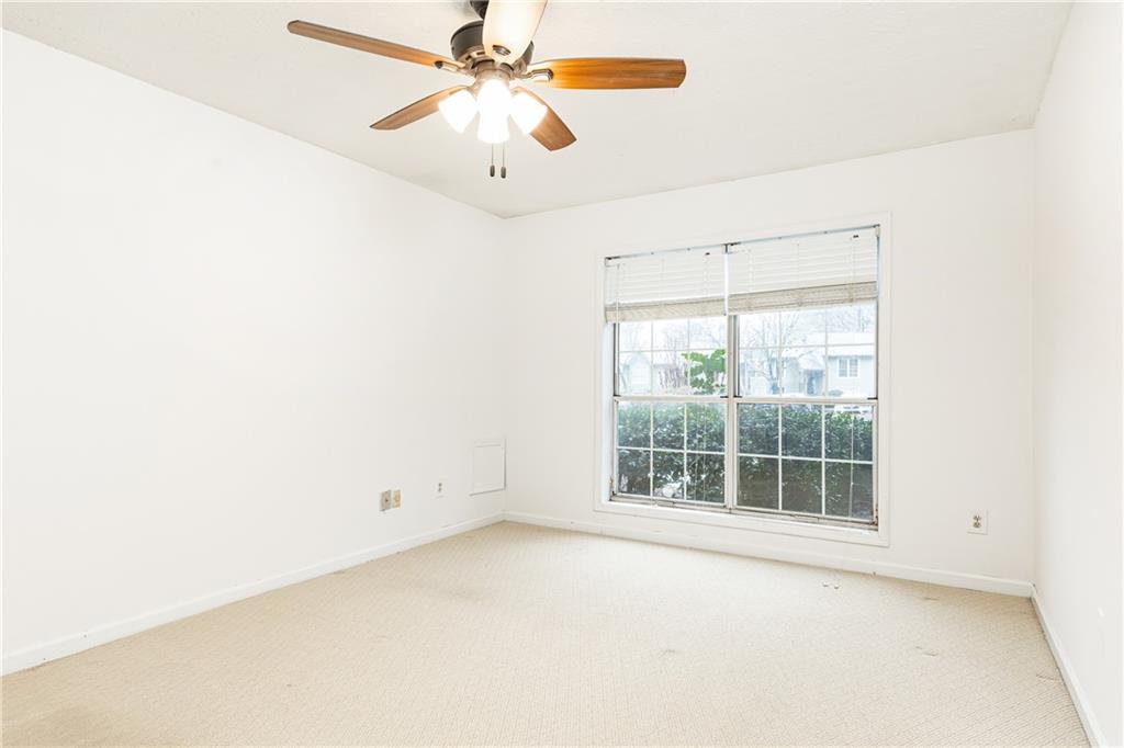 2901 Lenox Way Northeast, Unit 902 Atlanta, GA 30324 - Photo 25 of 34 an empty room with windows and fan