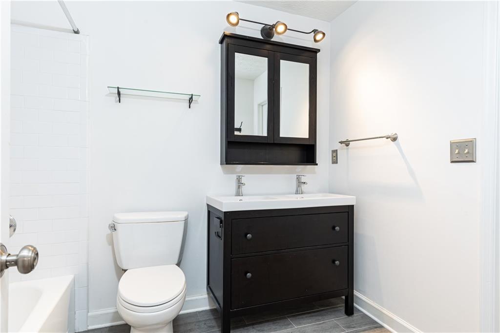 2901 Lenox Way Northeast, Unit 902 Atlanta, GA 30324 - Photo 27 of 34 a bathroom with a toilet a sink and mirror