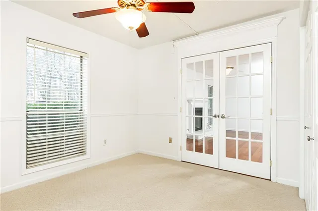 a view of a livingroom with a ceiling fan and window